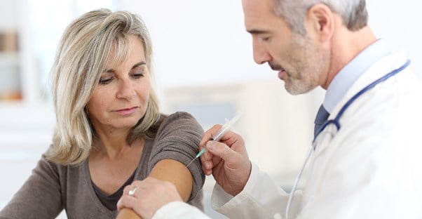 a woman getting a shingles vaccine