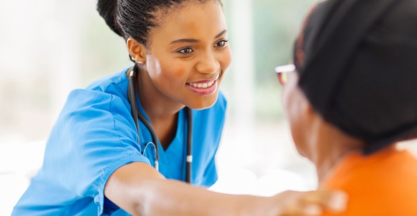a nurse talking to a woman living with sickle cell anemia