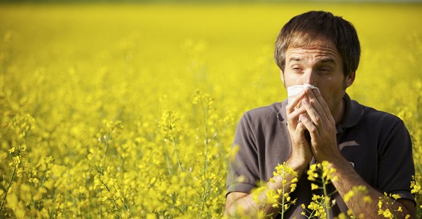 a man suffering from sinusitis in a field