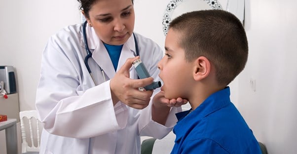 a boy with a respiratory condition that requires an inhaler