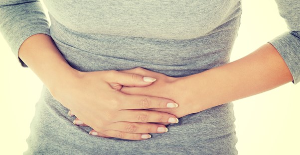 A woman feels the causes of irritable bowel disease