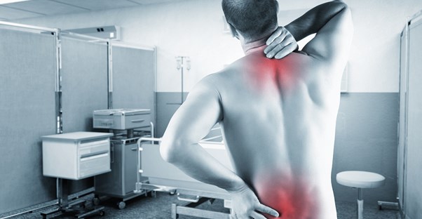 a man grabs his back in 2 places to show where his back pain is