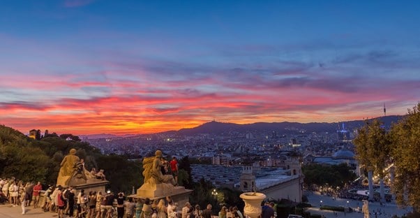 A Barcelona sunset creates beautiful colors on the horizon of the city.