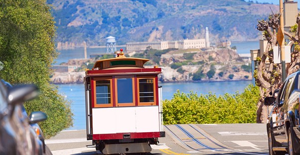 A streetcar trolley climbs up a hill in San Francisco.