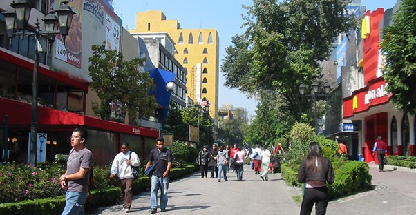 A street in Zona Rosa Mexico City is lined with chain and local restaurants.