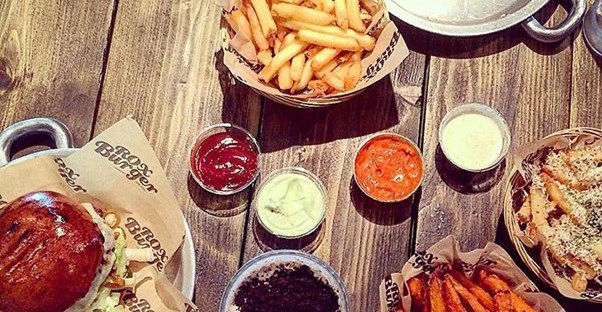 A spread of burgers and fries at Rox Burger in London, England.