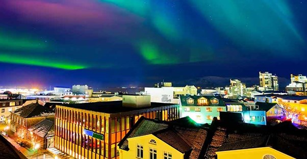 The Norther Lights (Aurora Borealis) over quaint buildings