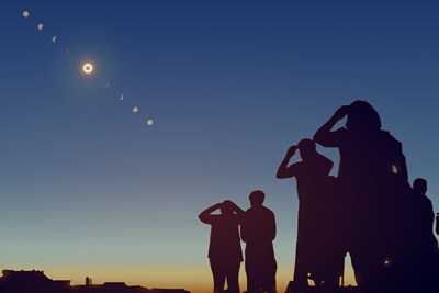 a group of people view the path of a solar eclipse