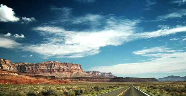 an open road headed towards the grand canyon