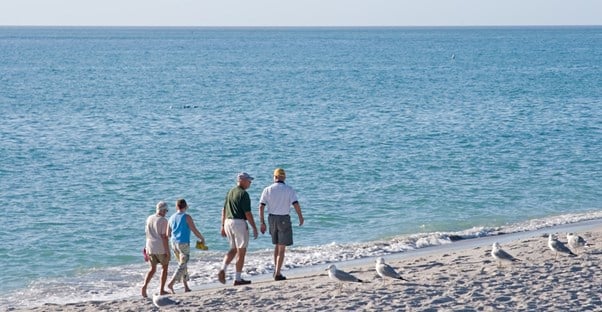 a family strolls the beaches of Sanibel Island, Florida