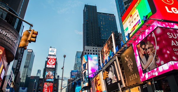 a panoramic view of the bright and colorful ad screens around Times Square