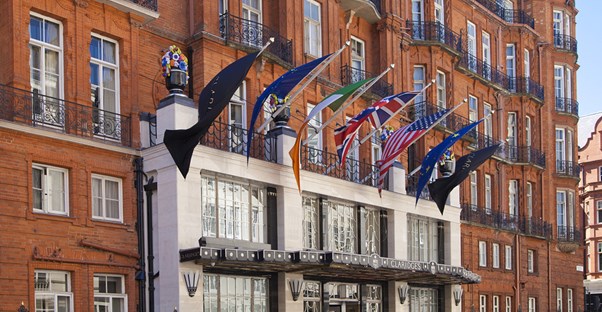 the ritz hotel with international flags displayed over the entrance