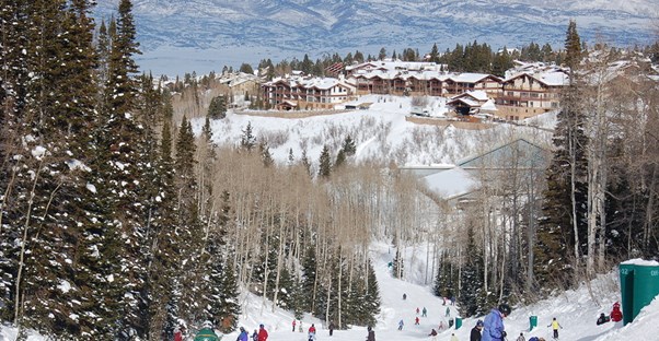a group of hotels sits at the bottom of a Park City Mountain Resort ski run