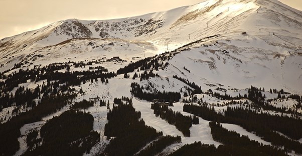 a landscape view of a mountain and its many ski runs
