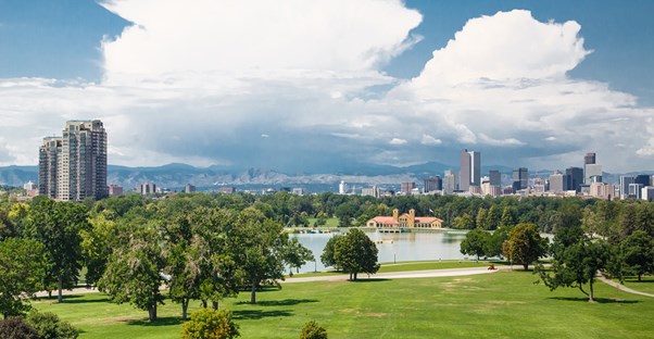 a park sits in front of the Denver skyline