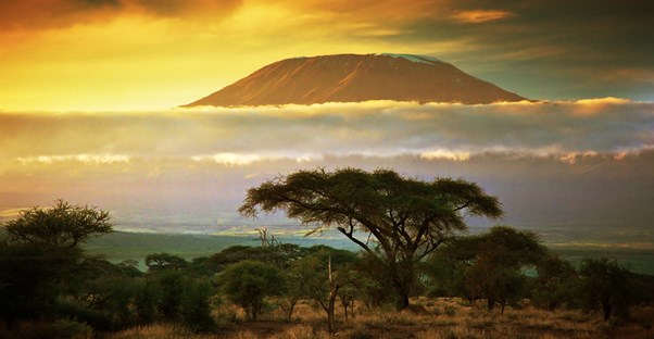 the sun sets behind mount kilimanjaro in Kenya