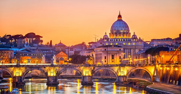 St. Peter's Basilica is lit up by colorful lights at night