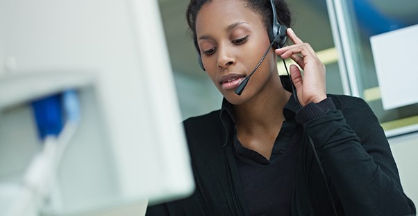 Woman at computer talking on headset