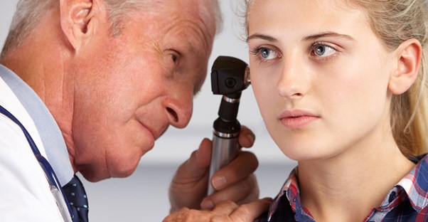 A creepy old man stares into the ear of a young woman