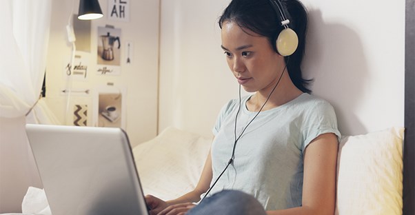 Woman listening to music on laptop