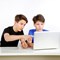 Two boys looking at a laptop computer