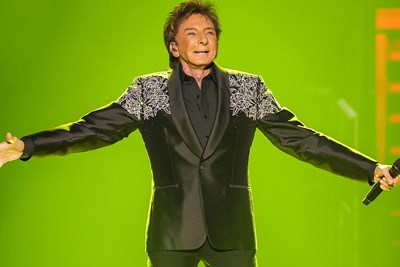 Brendon Urie in a red jacket and rainbow pride t-shirt