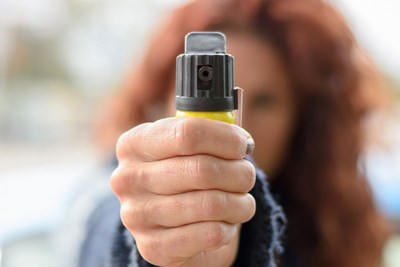 woman spraying pepper spray