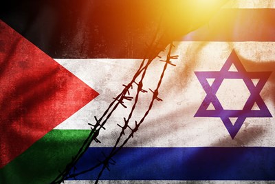 The Palestine and Israel flags separated by barbed wire