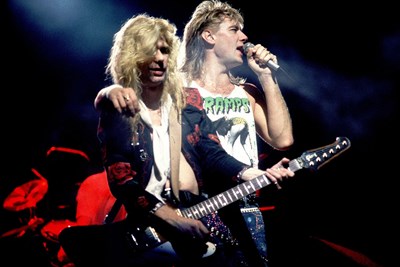 two members of def leppard on stage performing