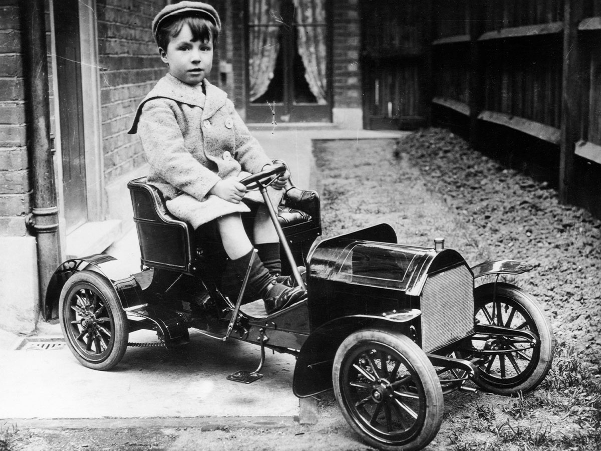 Boy in Toy Car, 1900s