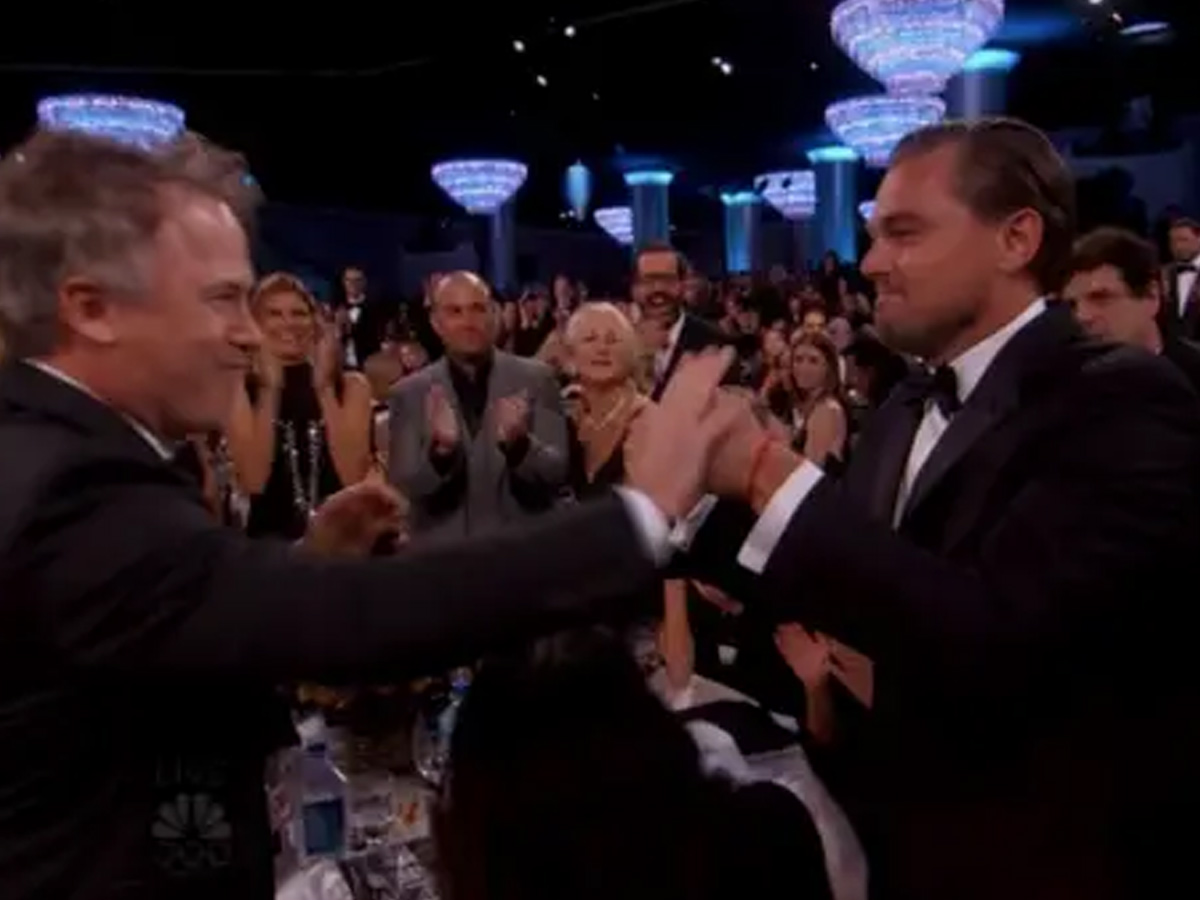 Leonardo DiCaprio fist bumps– high fives– no, wait…