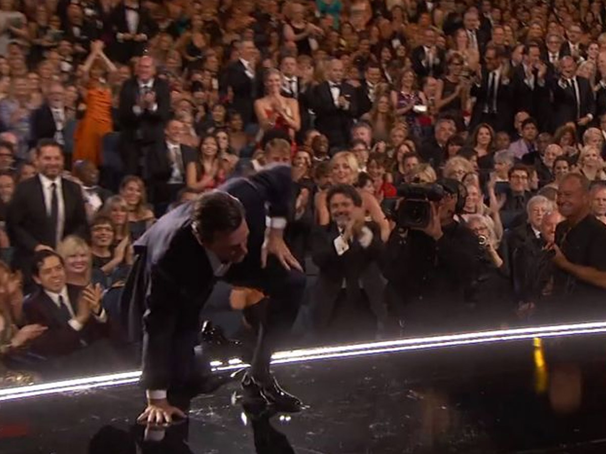 Jon Hamm crawls onto the stage
