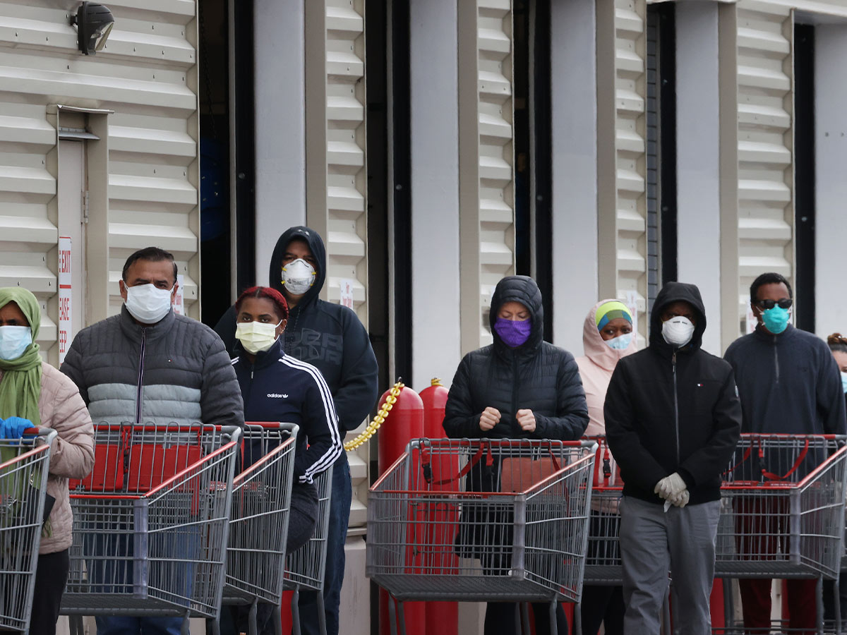 Customers Wearing Masks While Waiting in Line