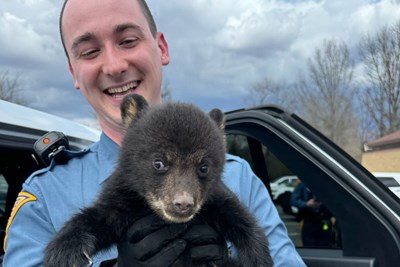 state trooper with a bear cub
