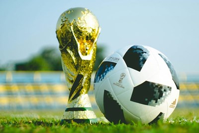 a world cup trophy and a soccer ball