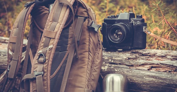 A backpack and camera taken on a camping trip.