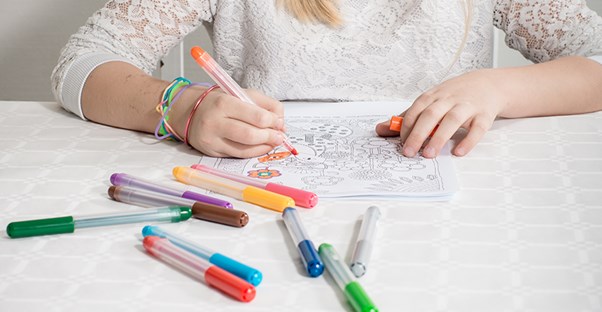 Girl coloring on coloring sheet