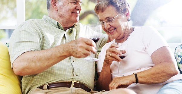 An older couple enjoying a glass of wine