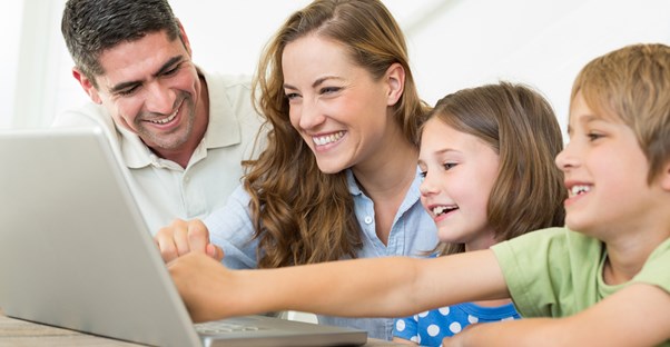 a family sharing a computer
