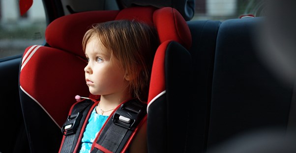 A little girl riding in her convertible car seat