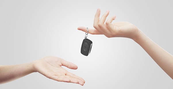 handing car keys to outstretched hand