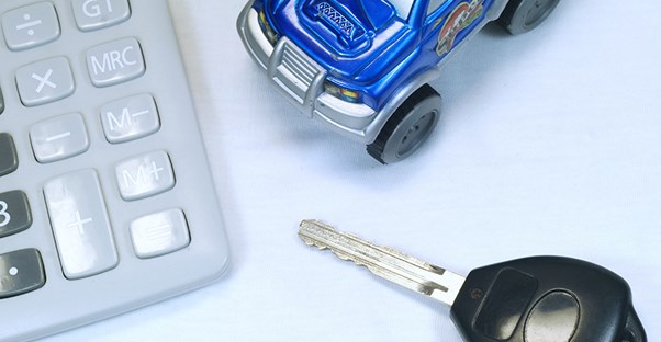 tiny car with car keys and calculator