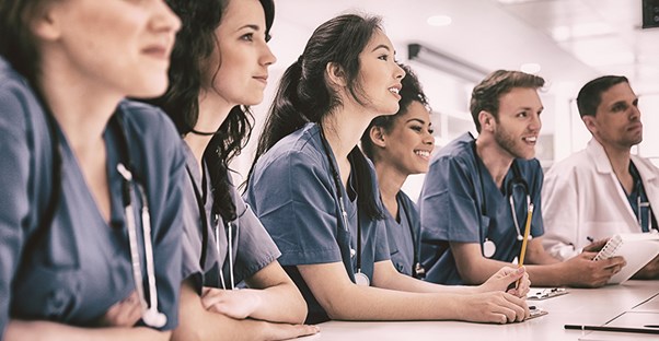 students in medical school line up and listen to their instructor