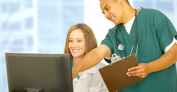 a medical assistant helping a doctor