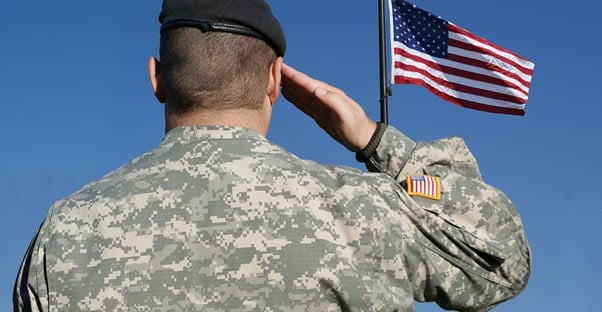 A soldier salutes the American flag