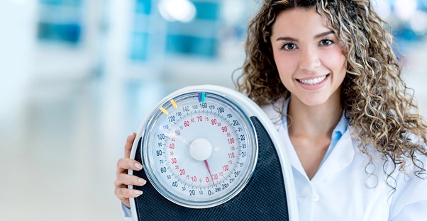 Nutritionist holds up a scale
