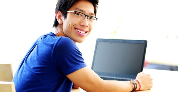 A young student completes his schoolwork online