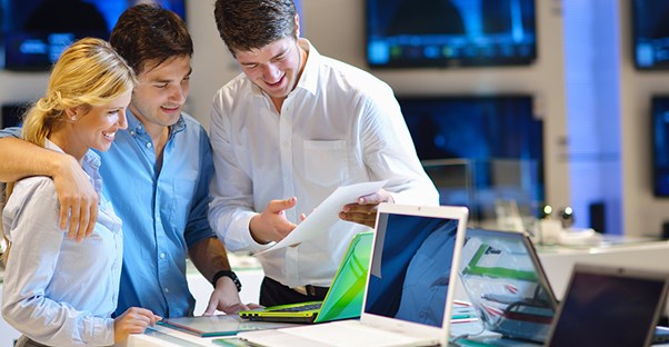 Couple with salesperson at computer store