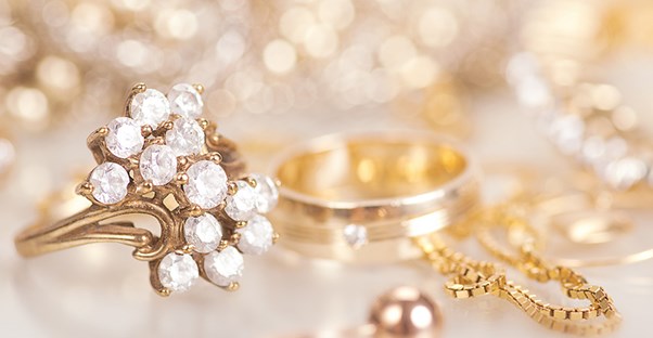 A collection of gold rings and diamond earrings.