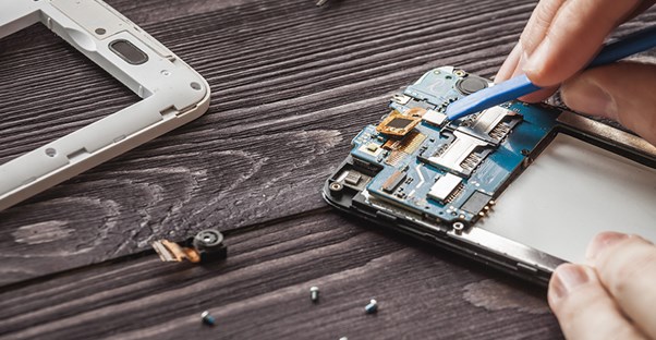 a cell phone is being taken apart and repaired